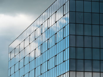 Blue sky and clouds reflected in the glass building