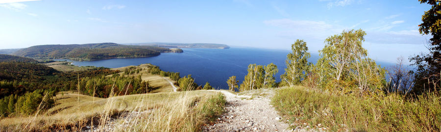 Panoramic shot of sea and trees against sky