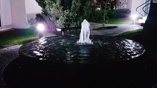 Water fountain in park at night