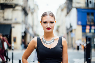 Portrait of beautiful model standing on city street