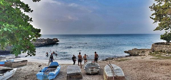 People on beach against sky