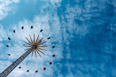 Low angle view of amusement park ride against sky