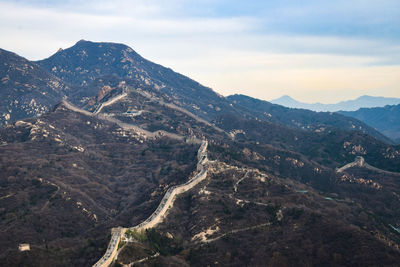 Aerial view of mountain range against cloudy sky