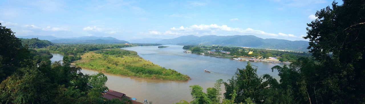 HIGH ANGLE VIEW OF RIVER BY MOUNTAINS AGAINST SKY