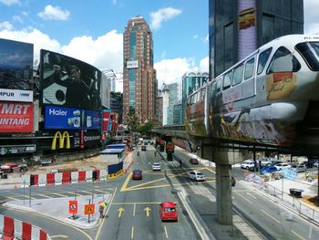 Cars on road in city against sky