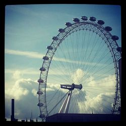 Low angle view of ferris wheel against sky