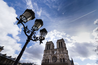 Low angle view of street light and building against sky