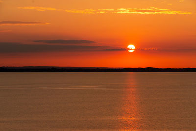 Scenic view of sea against romantic sky at sunset