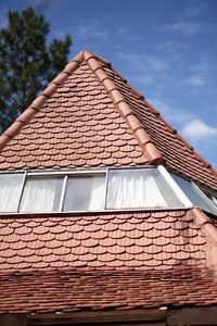 Low angle view of roof tiles against sky