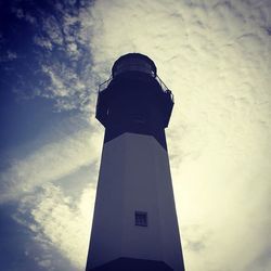 Low angle view of tower against cloudy sky