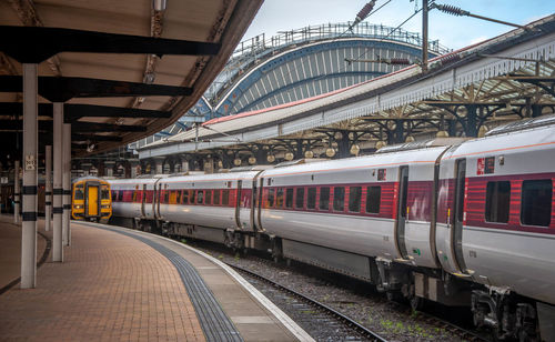 Train at york railway station showing arched roof, early in the morning before people have arrived