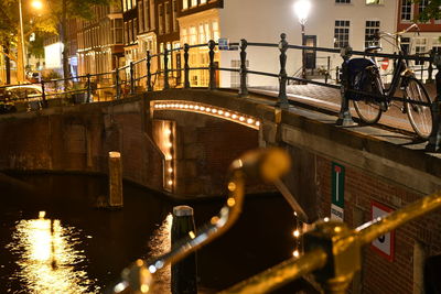 Bridge over canal in city at night