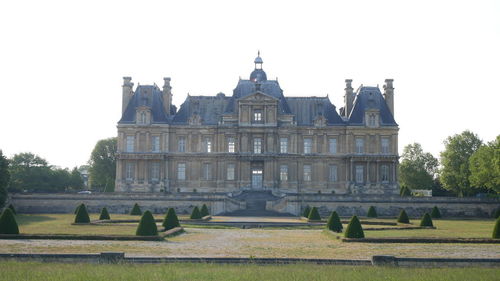 Facade of historic building against clear sky