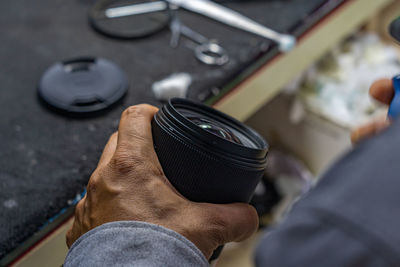 Midsection of man holding camera