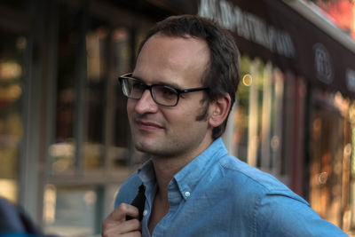 Young man wearing eyeglass looking away