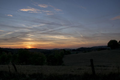 Scenic view of field against sky during sunset