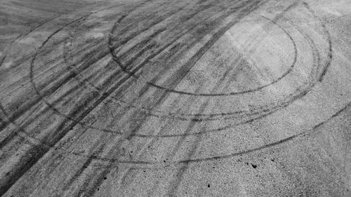 Aerial view tire track mark on asphalt tarmac road race track texture and background.