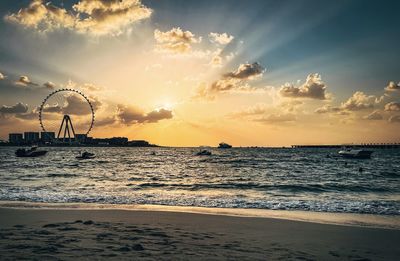 Scenic view of beach against sky during sunset