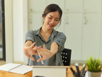 Businesswoman stretching while working at office