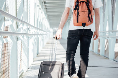 Midsection of man standing on railing