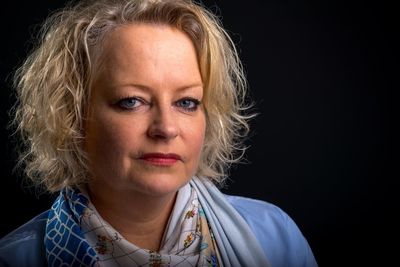 Portrait of woman against black background