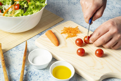 High angle view of man preparing food on cutting board