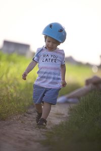 Portrait of boy standing on field