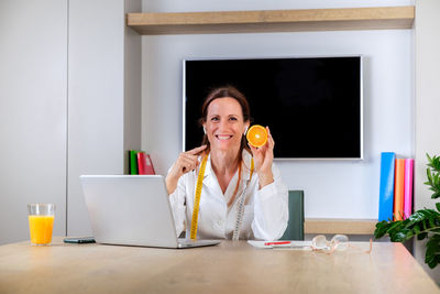 Young woman drinking glass at home