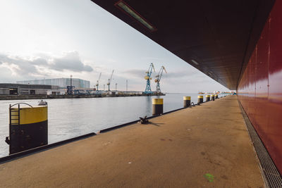 Commercial dock by sea against sky