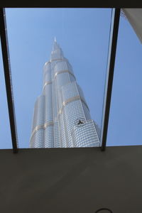 Low angle view of modern building against blue sky