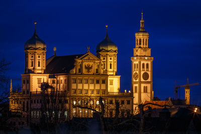 Illuminated building against sky at dusk