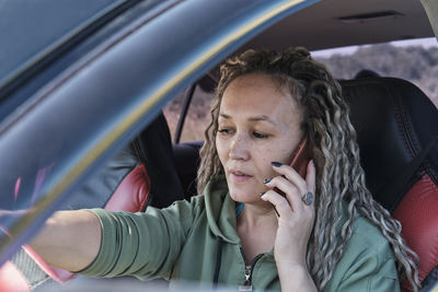 Portrait of woman sitting in car