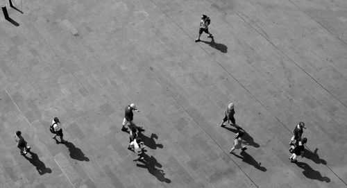 High angle view of people walking on floor