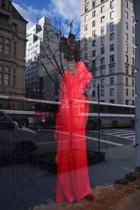 Reflection of red buildings in city