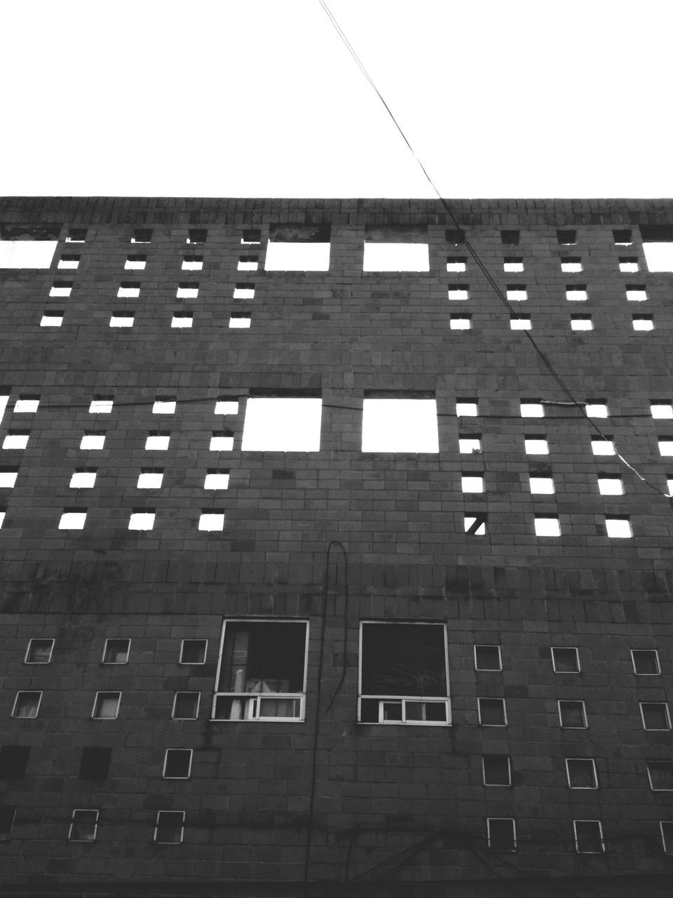 architecture, built structure, building exterior, low angle view, window, building, text, city, western script, clear sky, sky, no people, outdoors, day, office building, communication, modern, glass - material, brick wall, auto post production filter