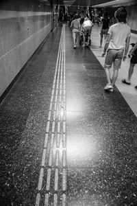 People walking on railroad tracks