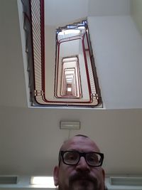 Directly below portrait of man against steps in building