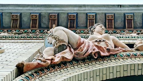 Statue against building