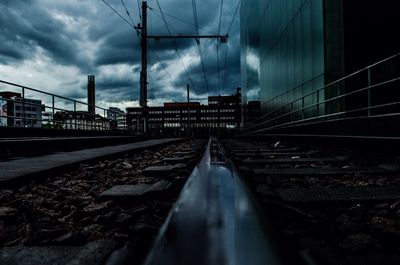 Railroad track against cloudy sky