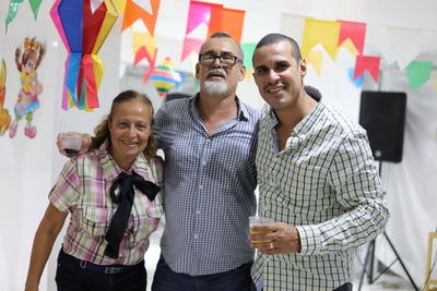 Portrait of smiling family standing at home