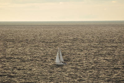 Boat sailing in sea against sky