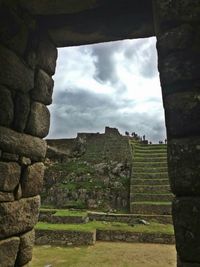 View of old ruins against cloudy sky