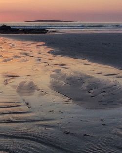 Scenic view of beach against sky during sunset