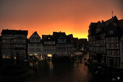 Scenic view of residential buildings against sky during sunset