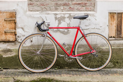 Bicycle parked against wall