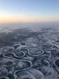 Aerial view of landscape against clear sky during sunset