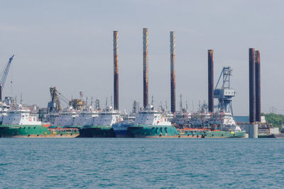 Commercial dock by sea against sky