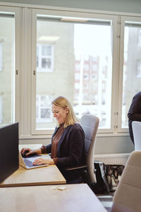 Smiling woman sitting at desk in office