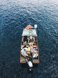 High angle view of men fishing on boat in sea