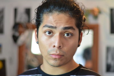 Close-up portrait of young man at home